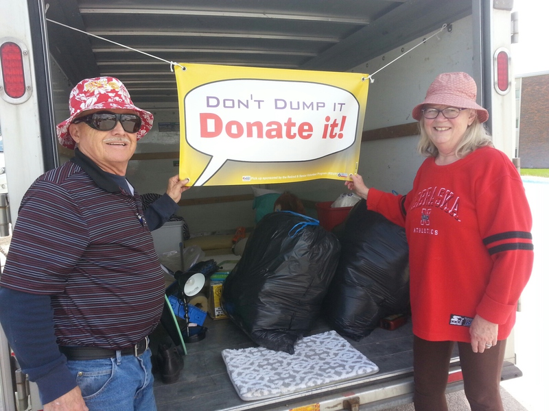 Norm and Janice Richardson with Chadron's Retired and Senior Volunteer Program pose with a trailer used to collect donated household items from Chadron State College students May 3, 2019.