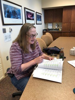 Chadron State College faculty member Dr. Mary Jo Carnot examines study data July 10, 2019.