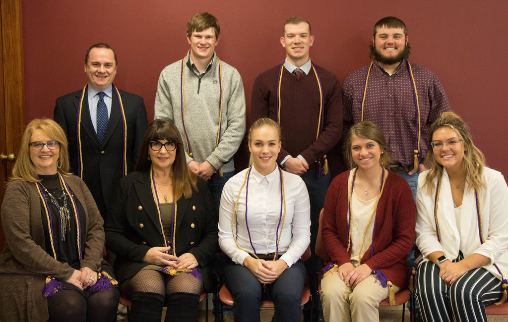 New members of the Chadron State College Chapter of Delta Mu Delta pose with chapter sponsors following the induction ceremony Thursday, Nov. 21, 2019, in the Student Center