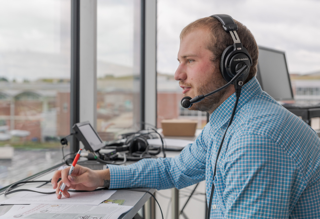 Devin Fulton commentates during a Chadron State football game in 2019.