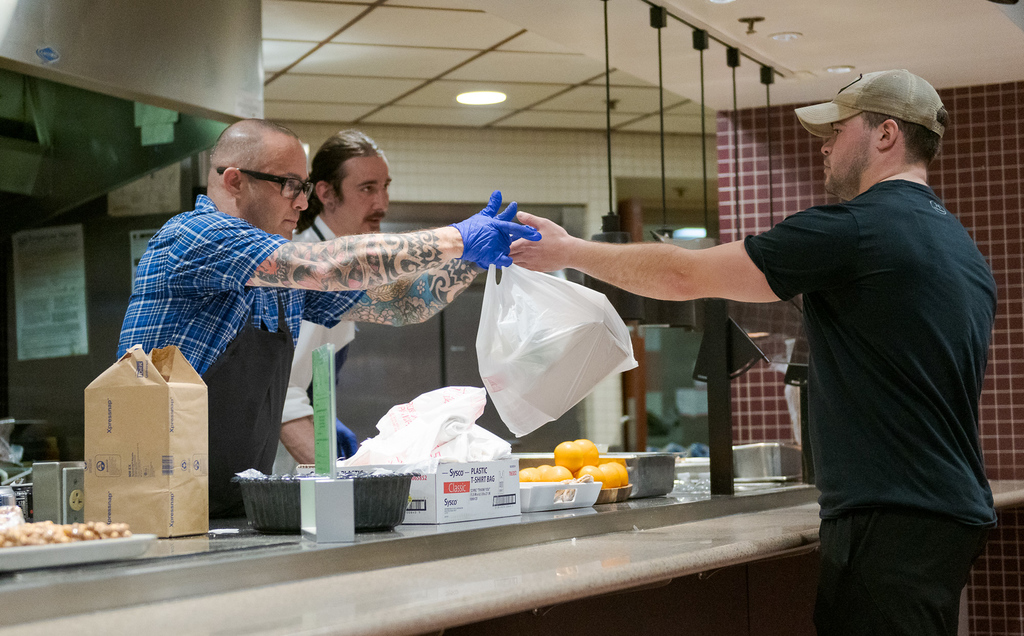 Beau Beckman collects his lunch-to-go from Food Service Director Stewart Lavender