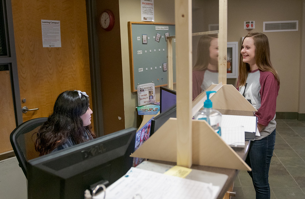 Work Hall Resident Advisor Kate Keffeler speaks to front desk worker Kyeisha Garza