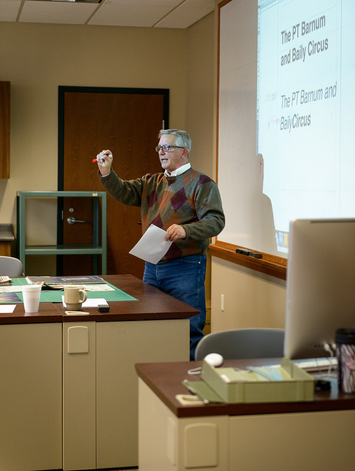 Michael D. Kennedy, instructor of communication, teaches design principles to a communication class.