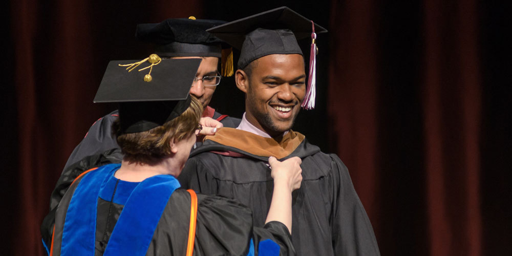 CSC graduate smiles at commencement