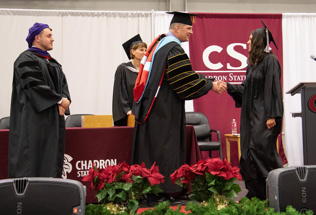 Dr.Rhine hands out diplomas at commencement