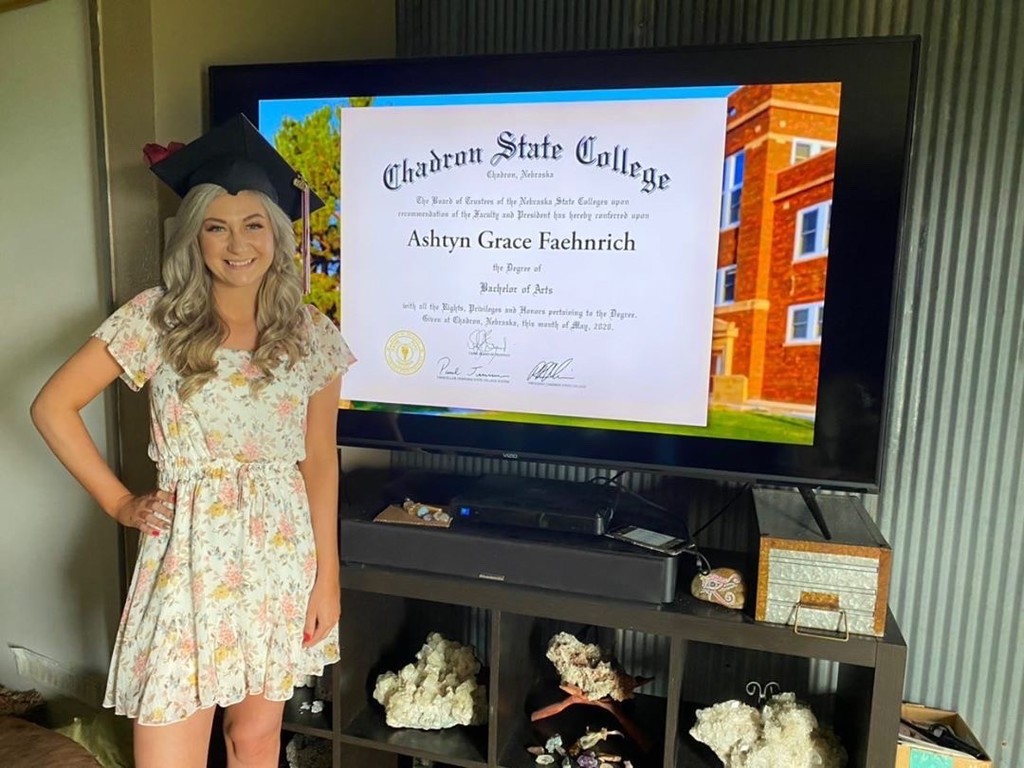 Chadron State College graduate Ashtyn Feahnrich poses with a screen shot of her diploma