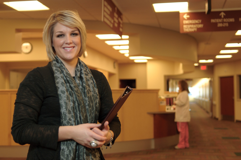 A lady poses holding a clipboard at the Chadron Medical Clinic