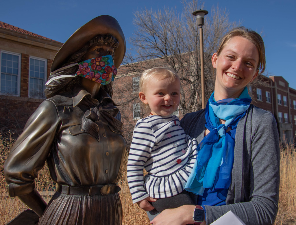 Rachel Brownlee poses with her daughter by the statue of her great-great aunt Mari Sandoz