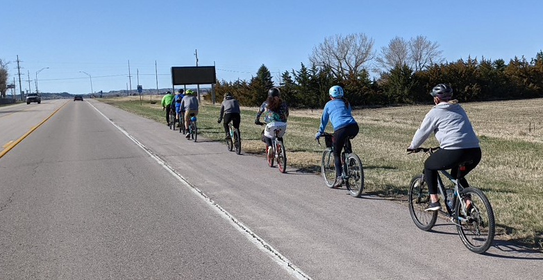 Students biking on the highway for the fundraiser