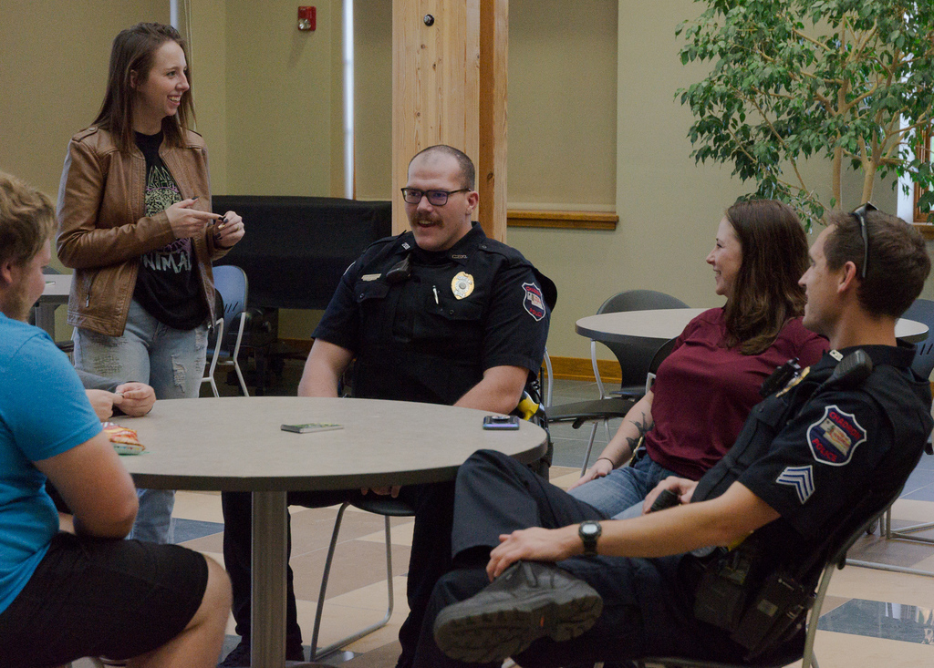 CSC students sit at a table and meet with law enforcers