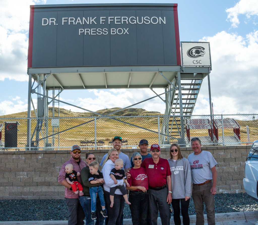 The Ferguson Family poses in front of the press box names after Dr. Frank Ferguson.