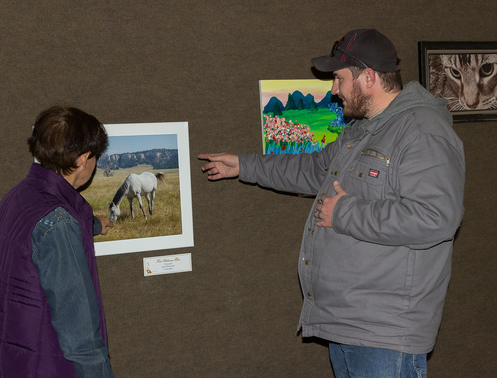 Viewers discuss the After Hours Artists show in Chadron State College's Mari Sandoz High Plains Heritage Center