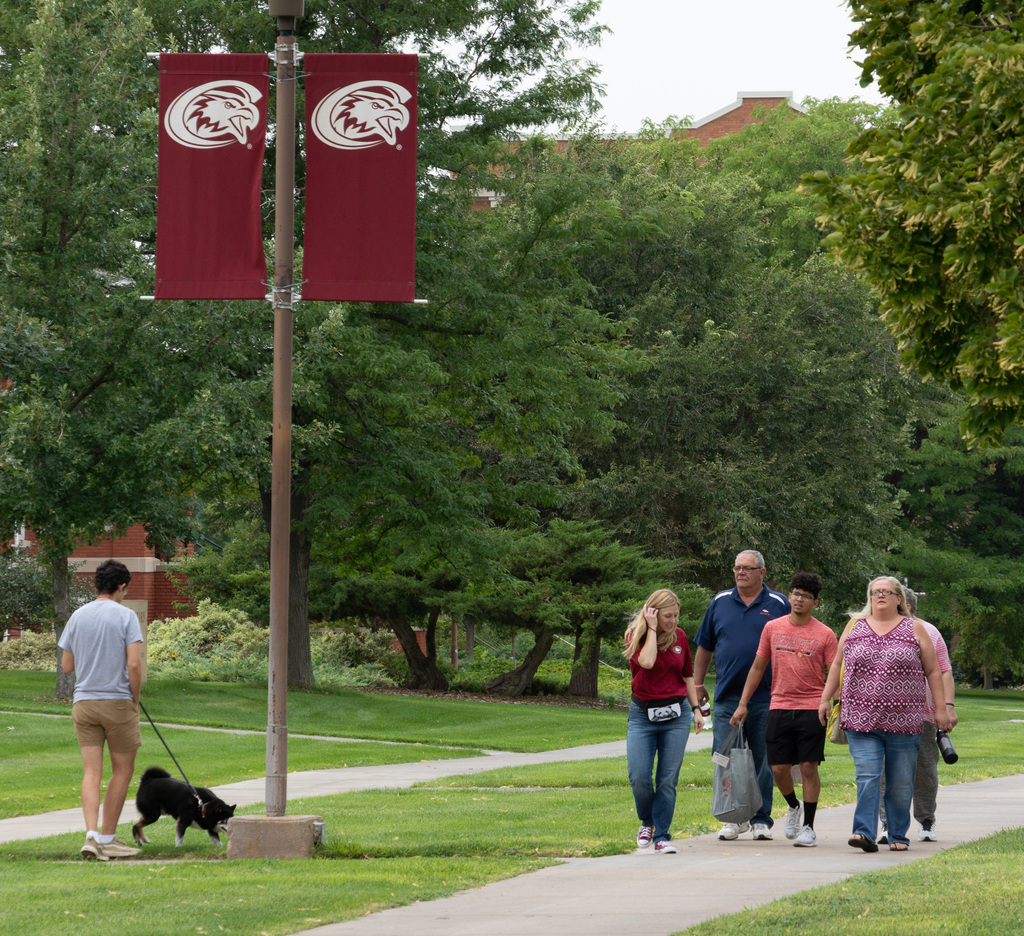 CSC Students and parents explore campus in front of the student center.