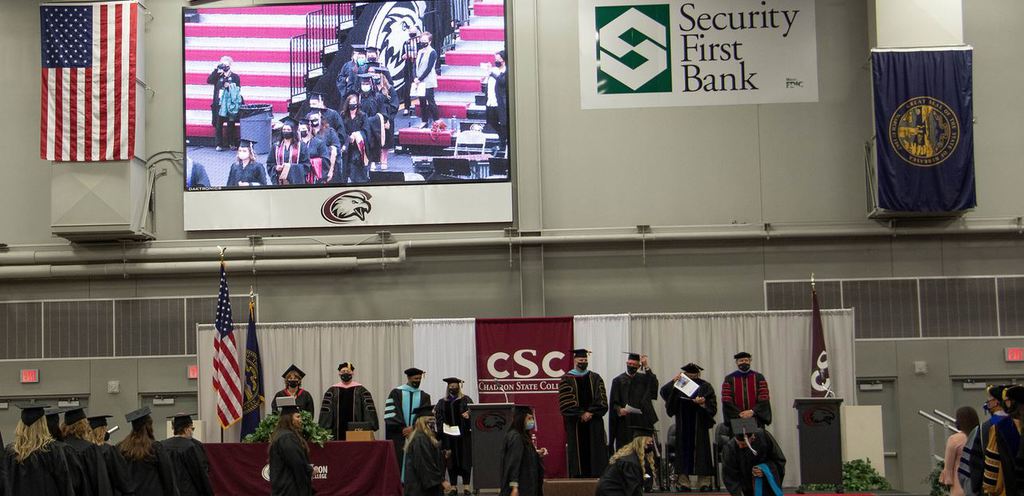 CSC students and staff stand on stage at the 2021 Fall Commencement Ceremony