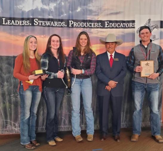 Four students holding the Rangeland Cup after winning