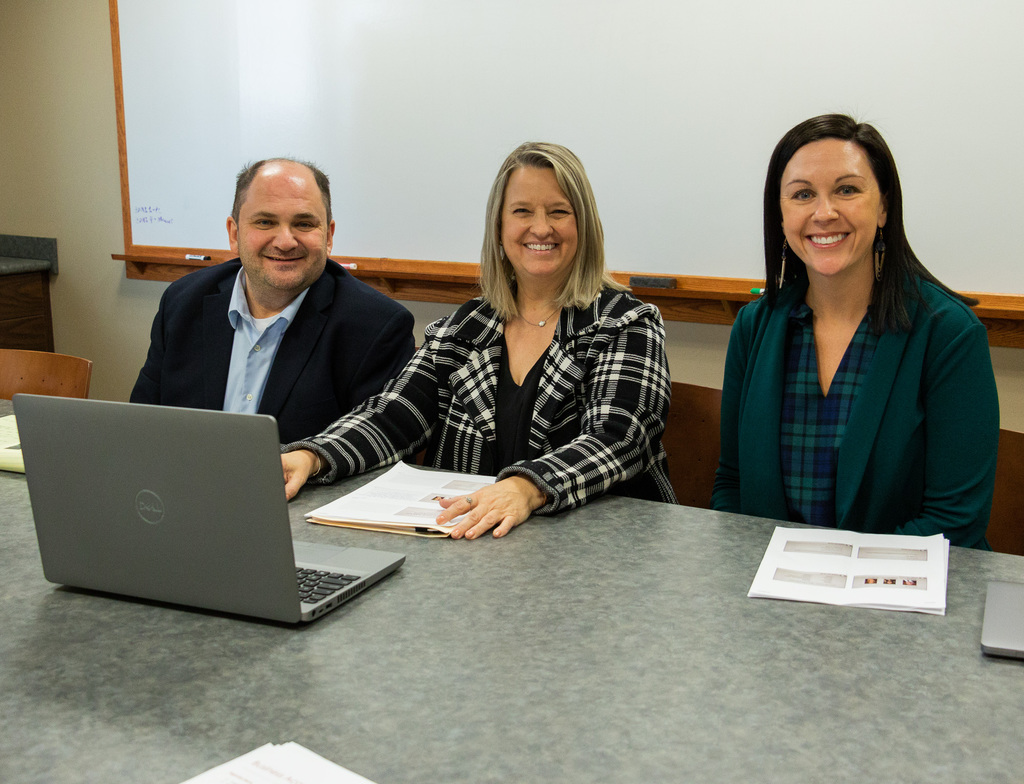 Three CSC faculty and staff members before they present in front of students.