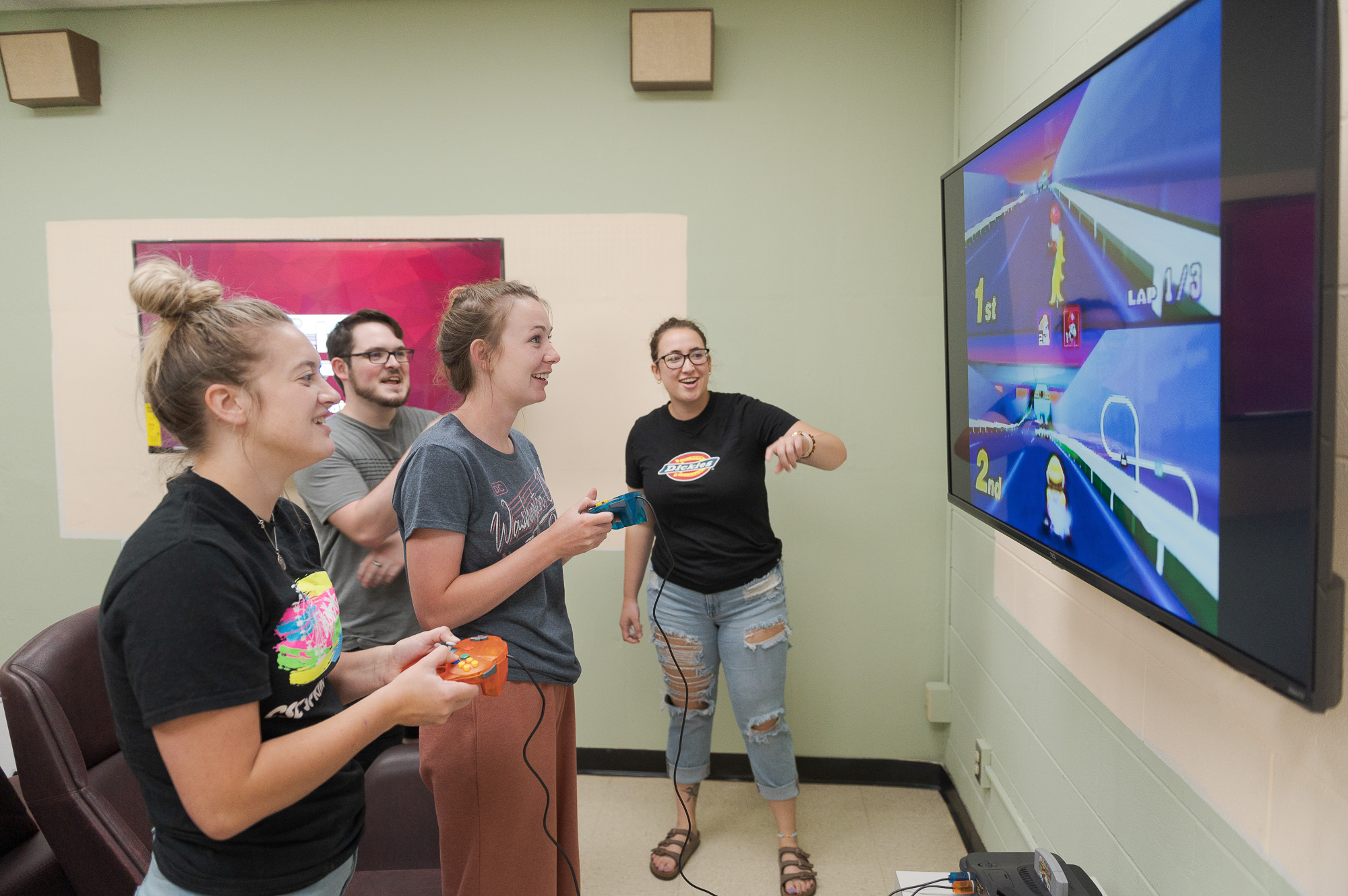 Students play a racing game in the video game room at the King Library