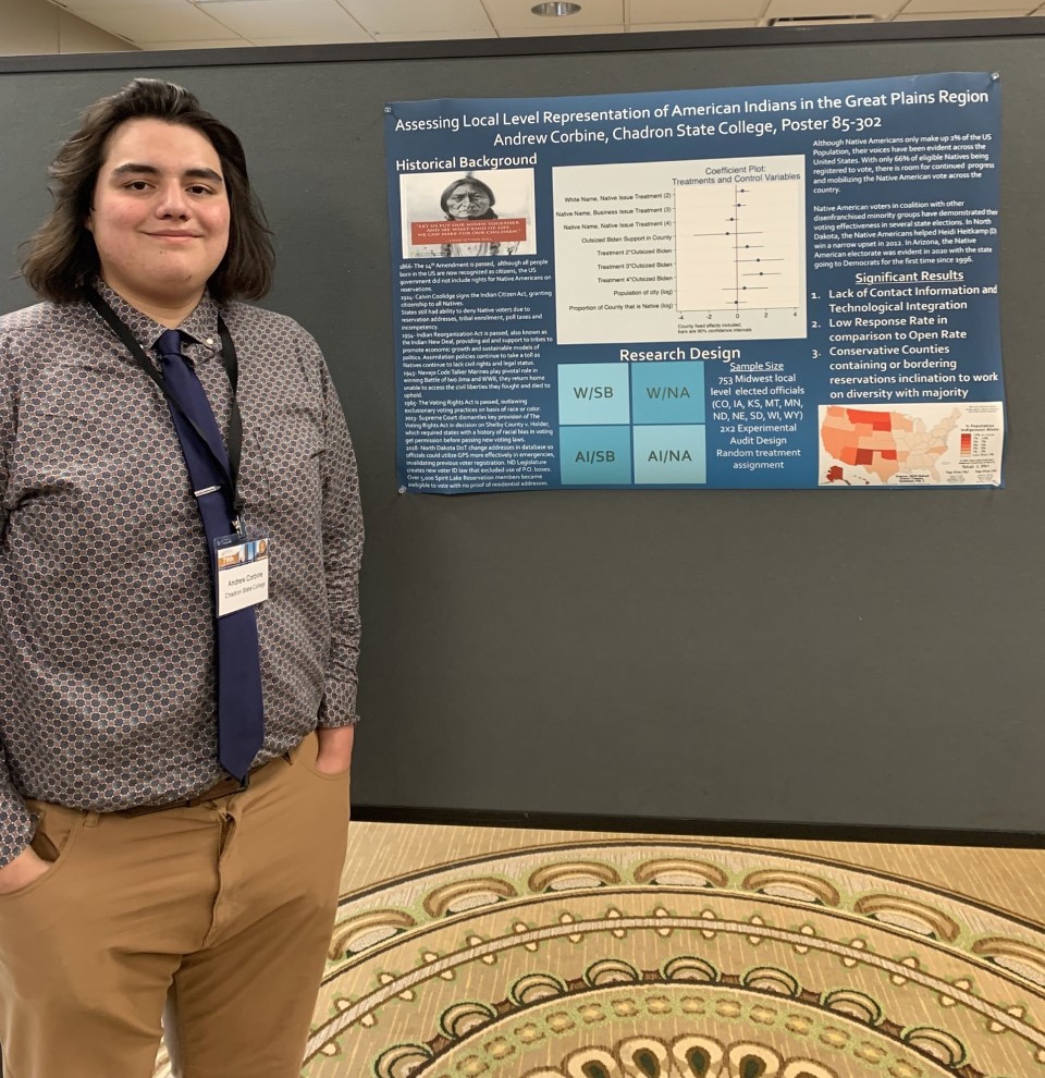 Andrew Corbine stands in front of his political science presentation board