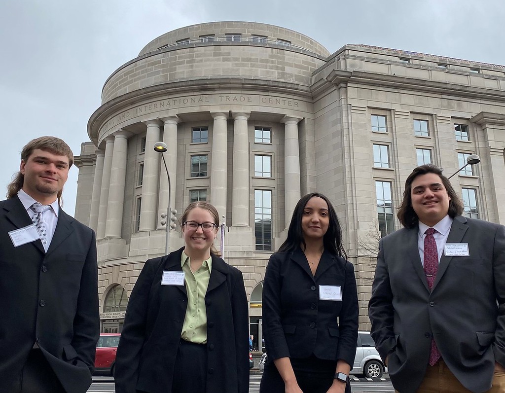 Four CSC Students pose in front of International Trade Center