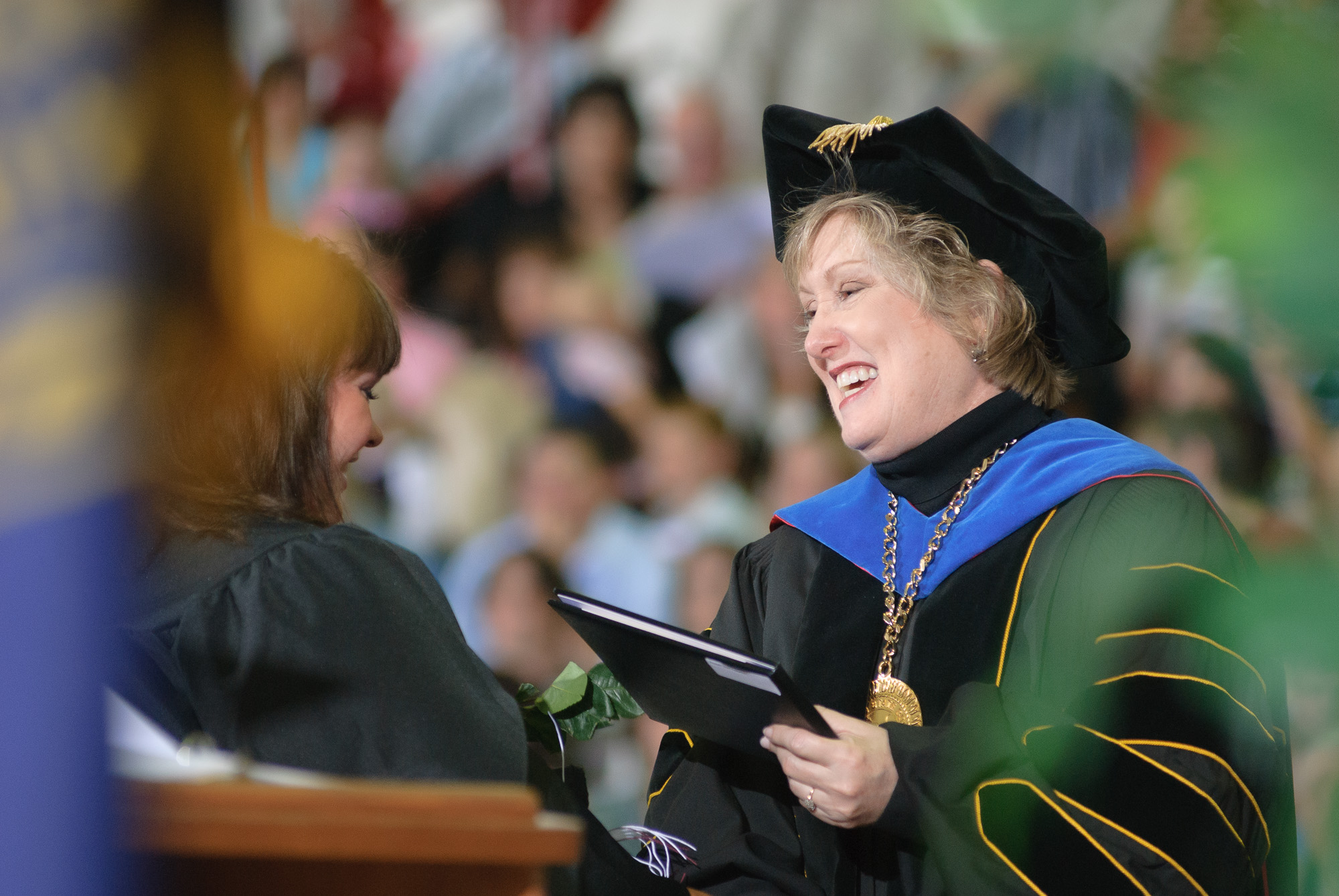 Chadron State College President Janie Park congratulates a graduate at commencement