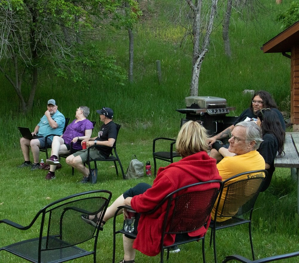 People sitting in a circle outside