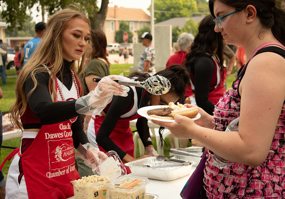 A cheerleader serving a meal