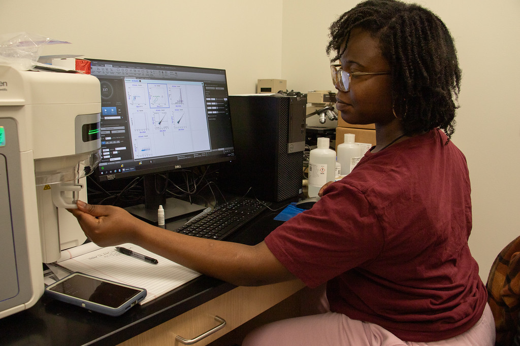 Student working with scientific equipment