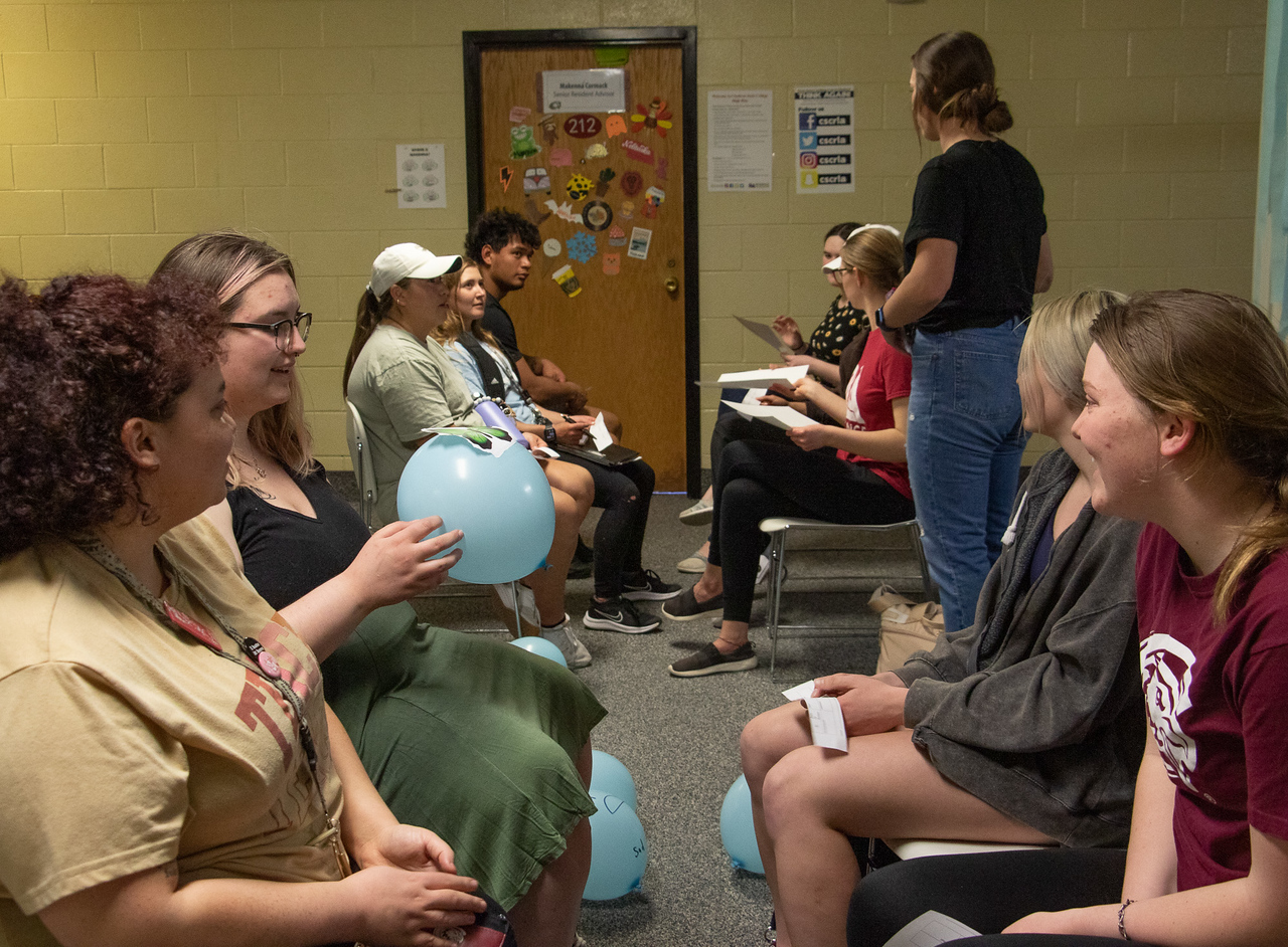 Students involved in an activity with a balloon