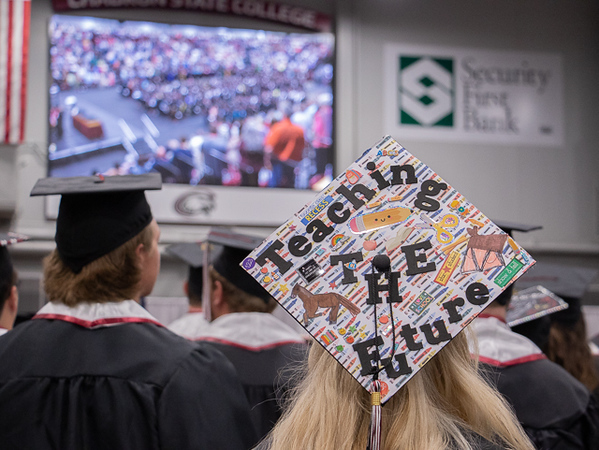 Large screen above crowd at graduation