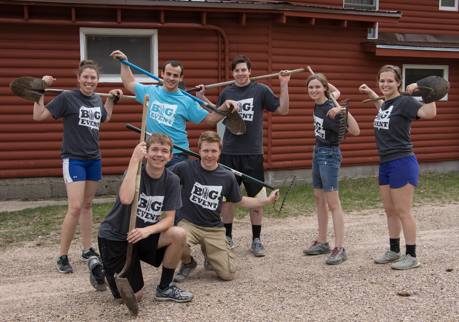 Students posing with rakes and shovels