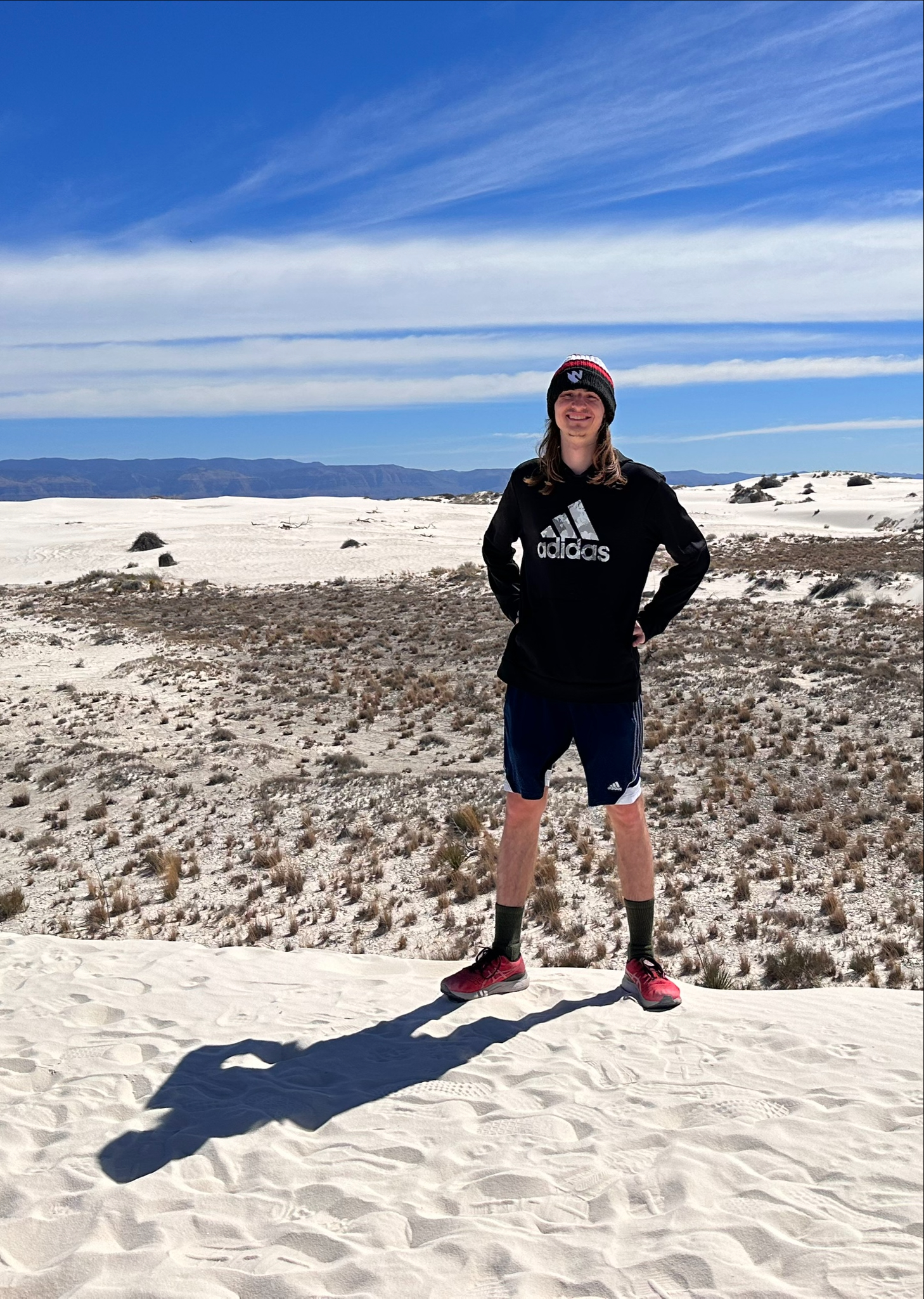 Student standing on sand