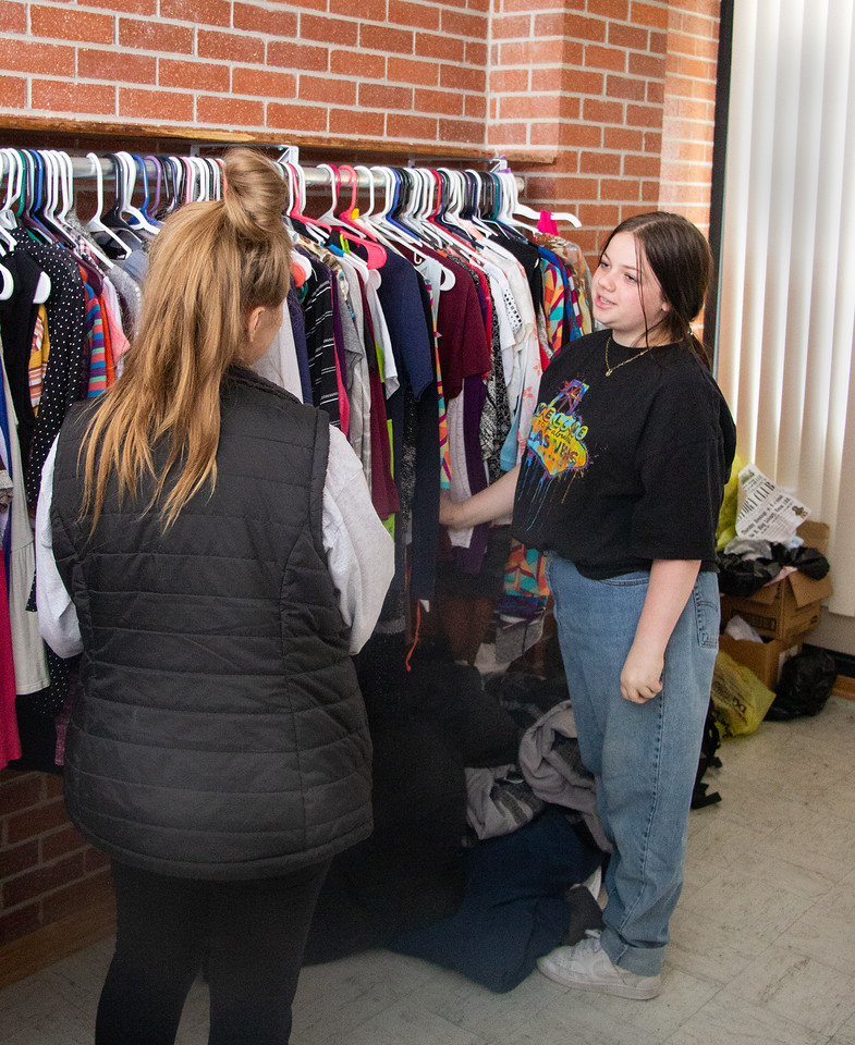 Two young women at a clothing rack