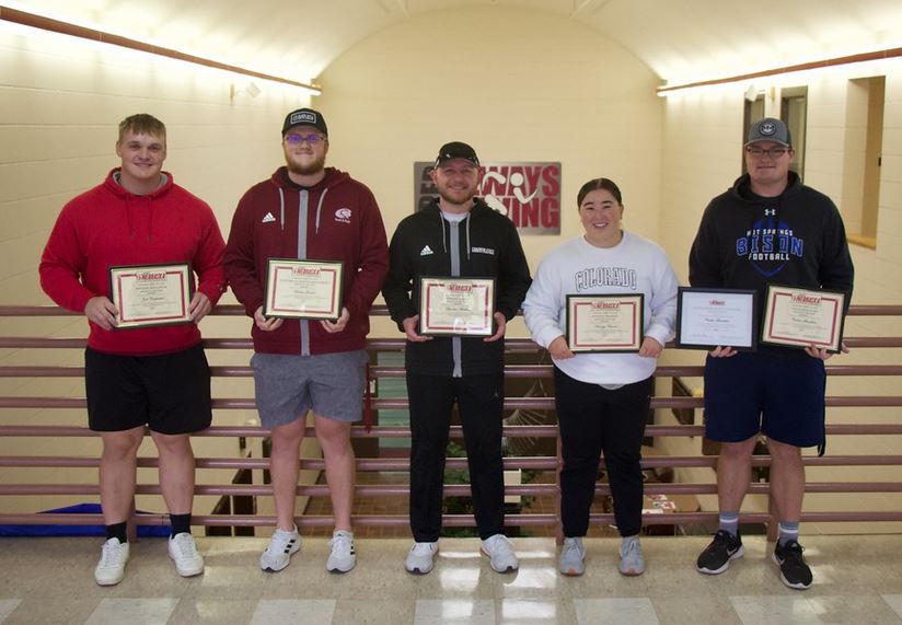 Students holding award certificates