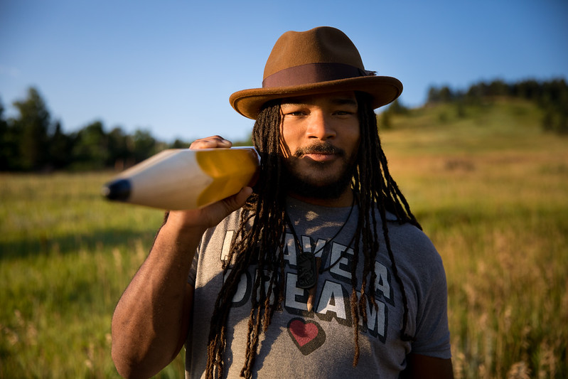 Man in a field posing with a pencil prop