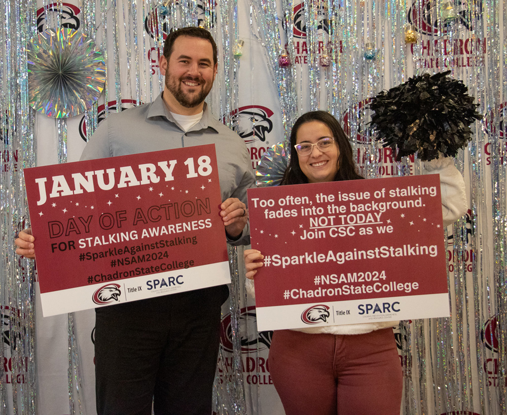 Two adults pose to promote stalking awareness