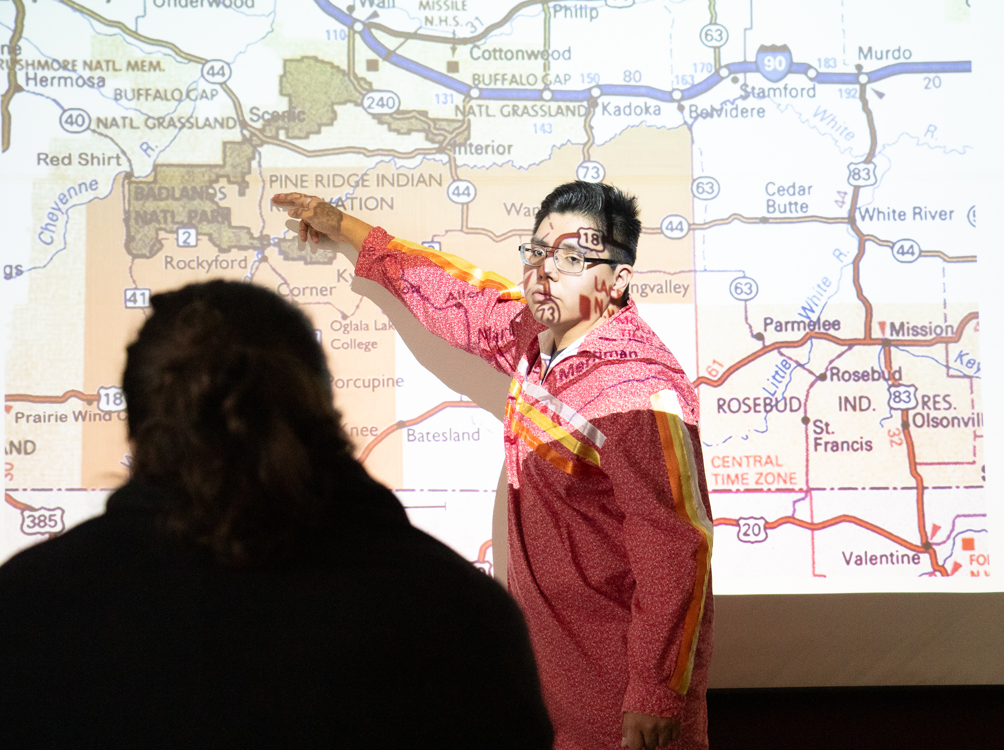 Student pointing to a map