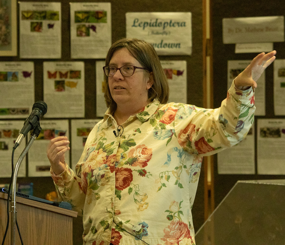 Adult female making a presentation at a podium