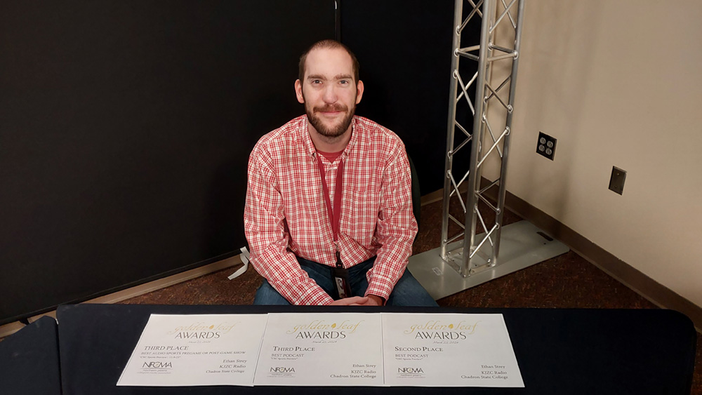 Student holding a certificate