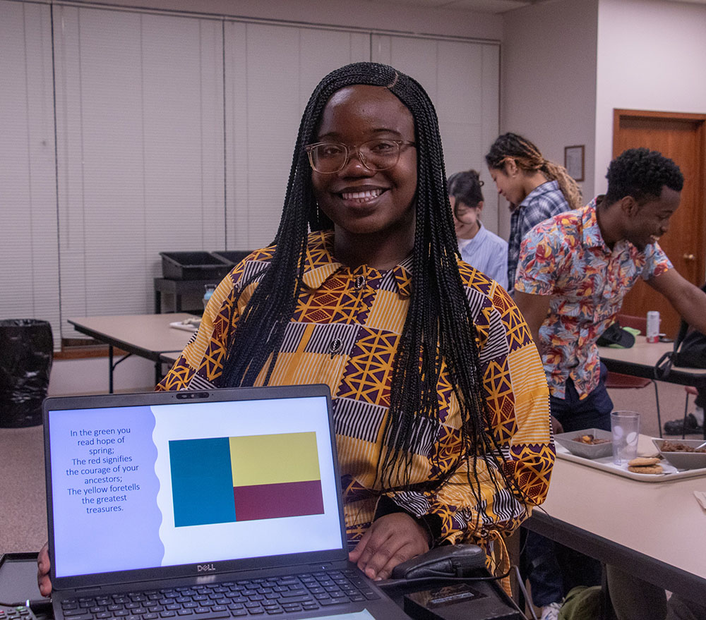 Woman posing with a laptop