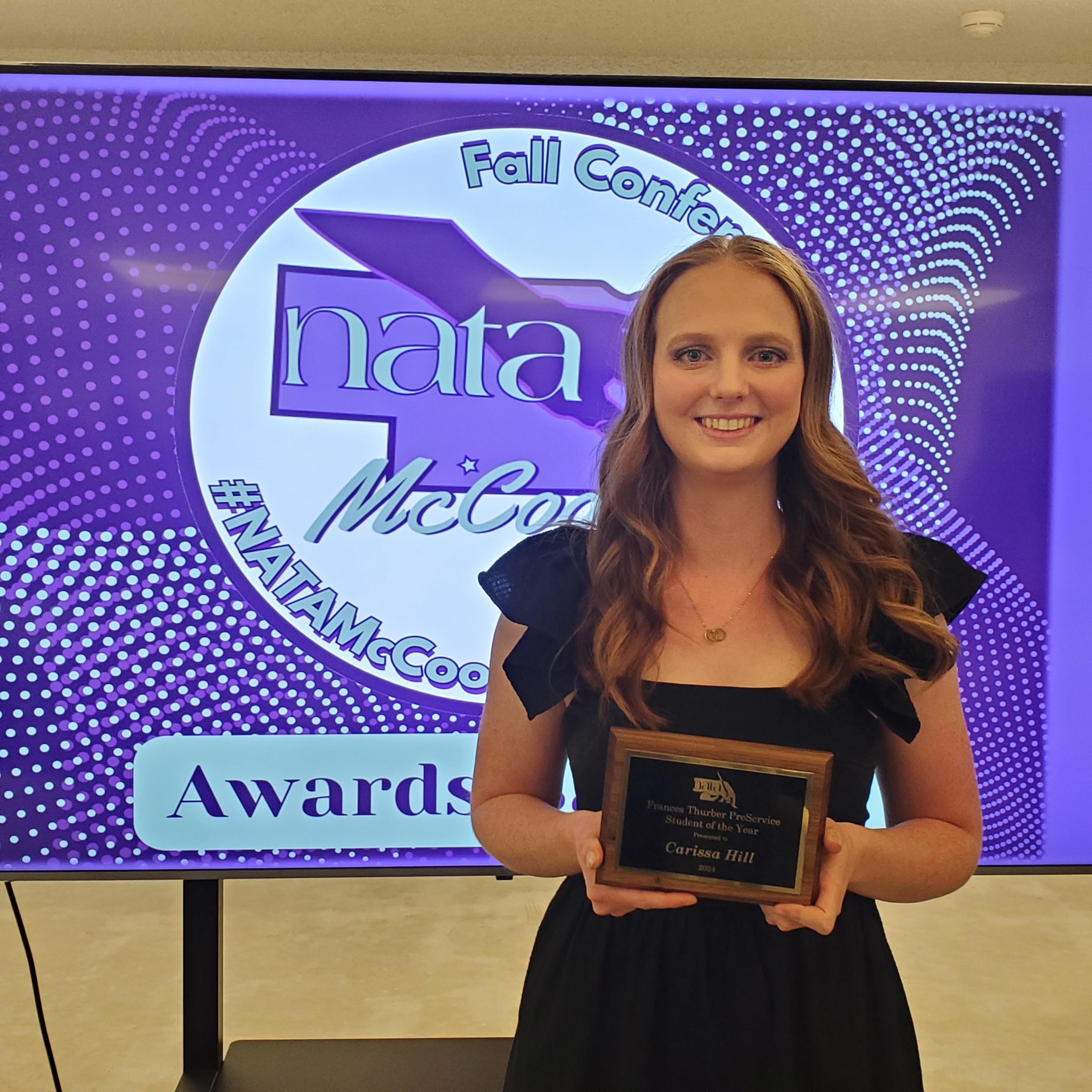 Woman posing with an award