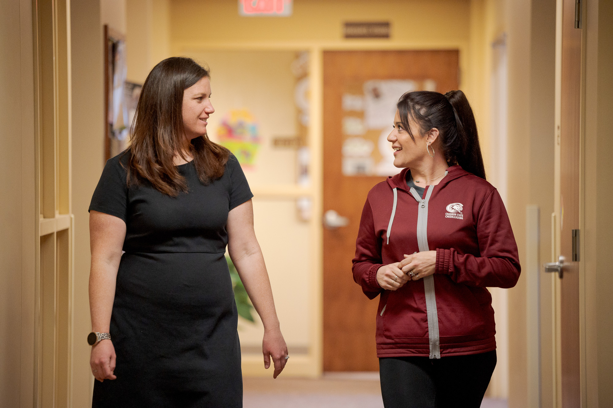 Two women walking in a hallway