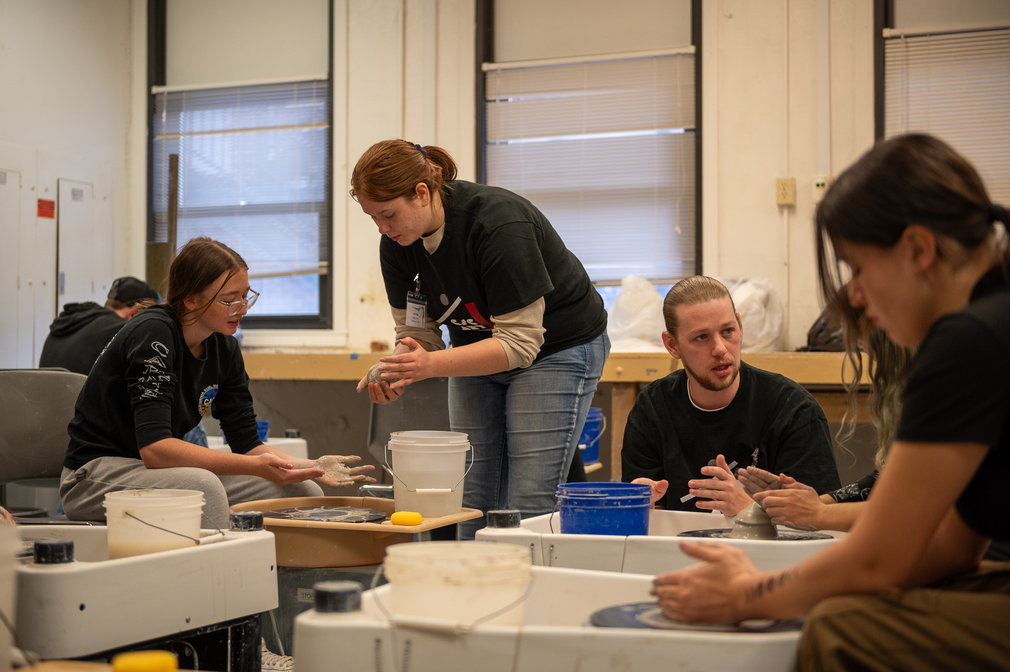 Chadron State College Art majors assist students during a ceramics workshop at Art Day, Nov. 5, 2024 (Photo by Sydney Brown/Chadron State College)