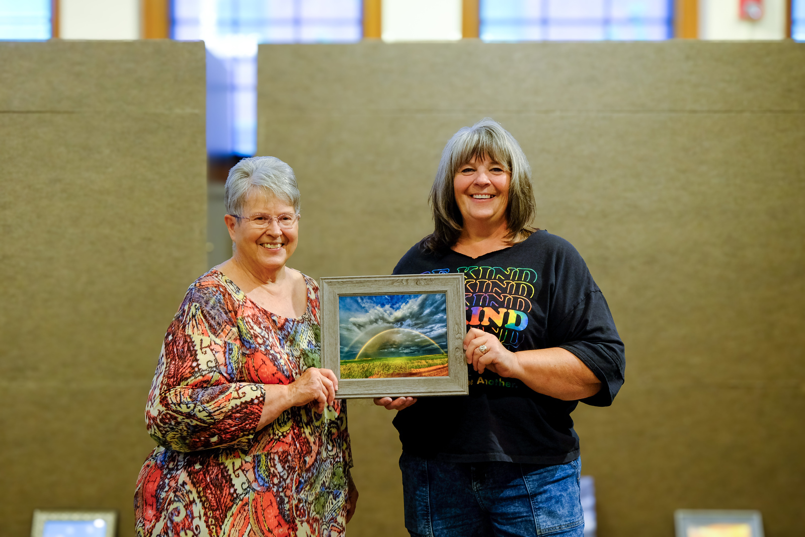 Two women posing in an art gallery