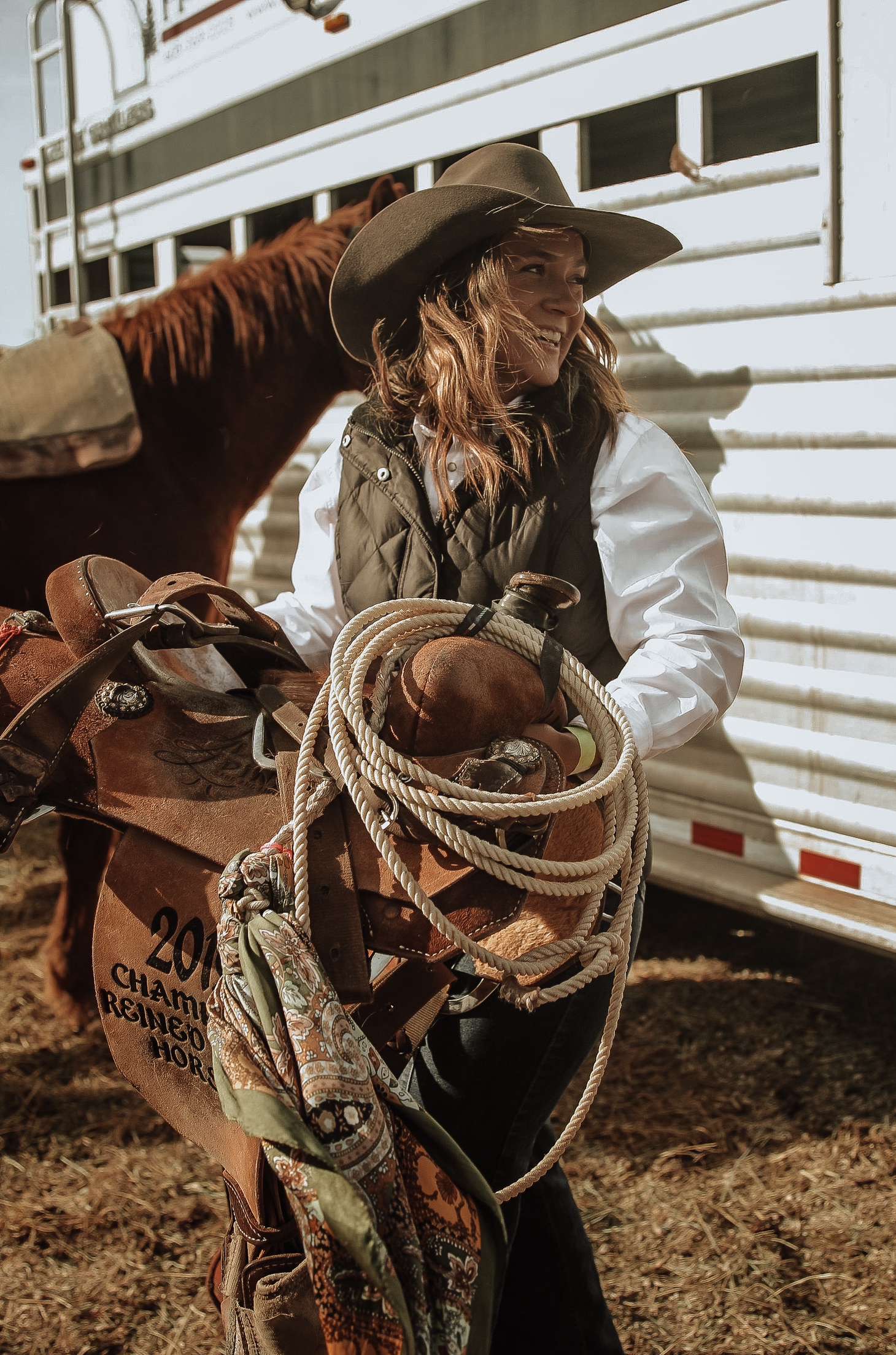 Woman holding a saddle