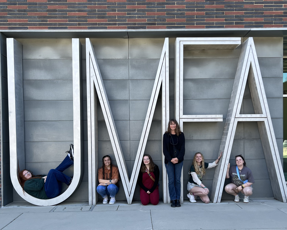 Adults posing outside a museum