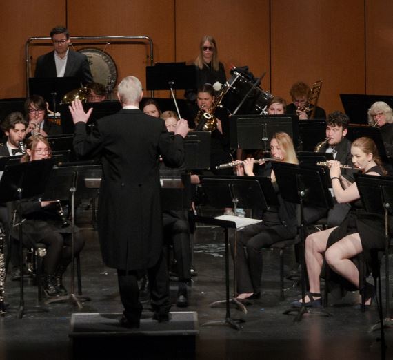 Band leader and musicians performing on stage