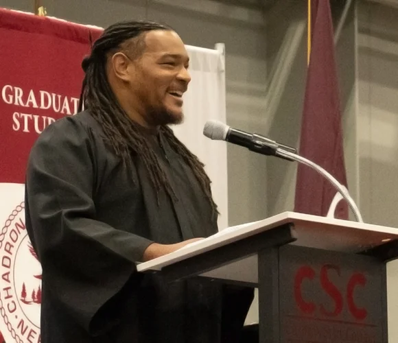 Man speaking at a lectern