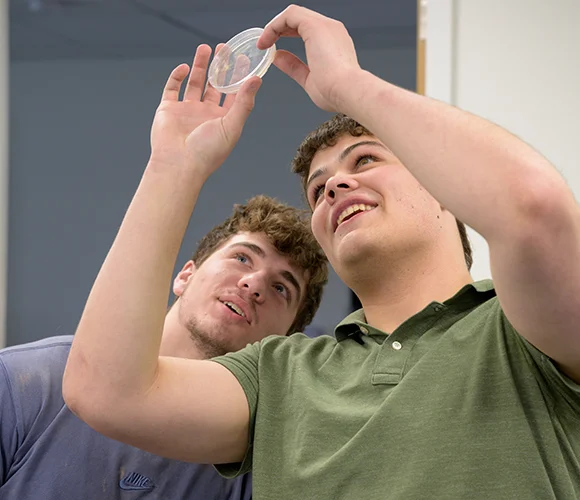 Two science students examining a sample