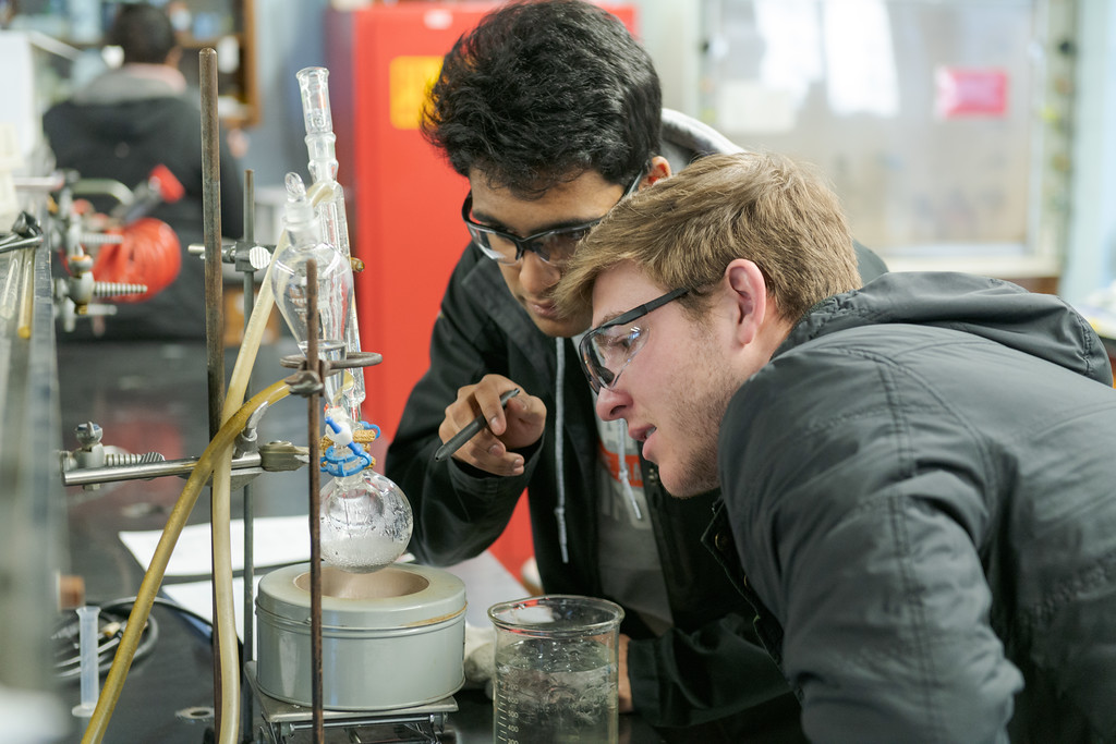 Two students work on a synthesis project during an organic chemistry lab.