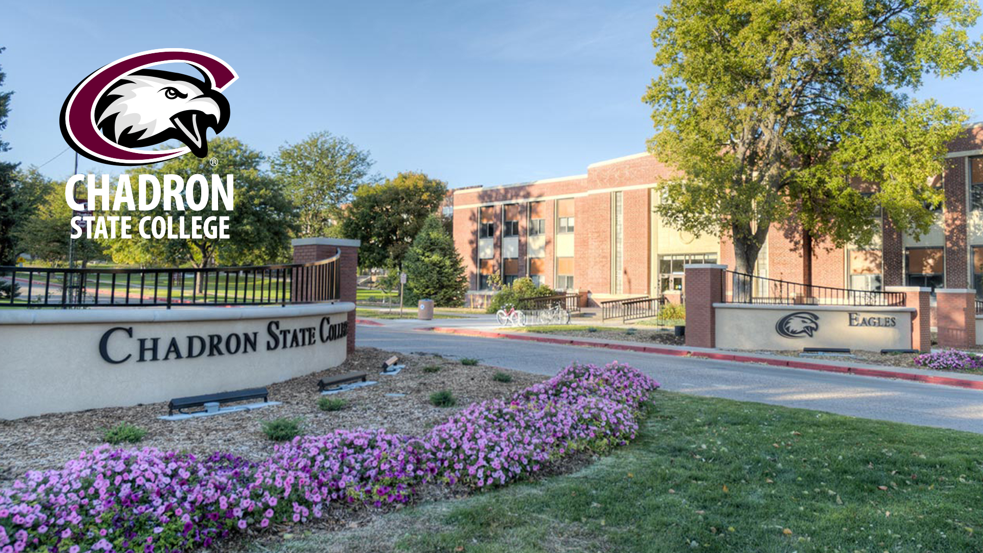 An image of the entry to Chadron State College from 10th & Main St. CSC Eagle logo with Chadron State College words underneath in white lettering. Left brown wall says Chadron State College. Right wall says Eagles.